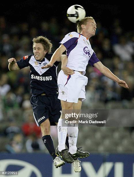 Evan Berger of the Victory is beaten in the air by Scott Bulloch of the Glory during the round seven A-League match between the Melbourne Victory and...