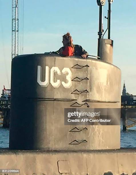 This photo shows allegedly Swedish journalist Kim Wall standing in the tower of the private submarine "UC3 Nautilus" on August 10, 2017 in Copenhagen...
