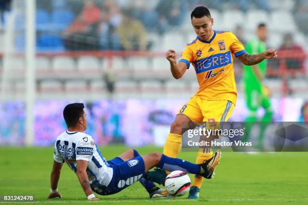 Lucas Zelarayan of Tigres struggles for the ball with Emmanuel Garcia of Pachuca during the 4th round match between Pachuca and Tigres UANL as part...