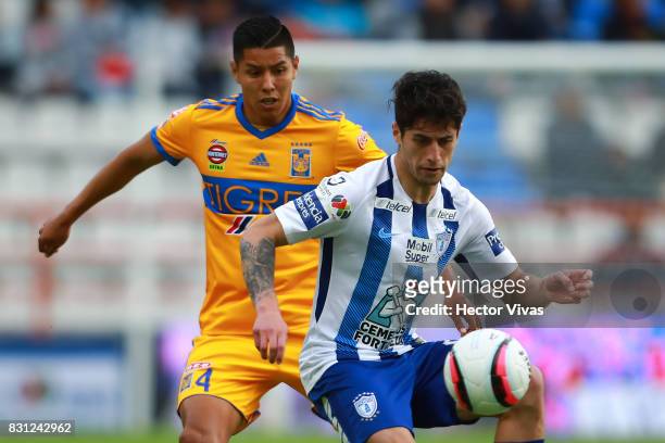 Hugo Ayala of Tigres struggles for the ball with Angelo Sagal of Pachuca during the 4th round match between Pachuca and Tigres UANL as part of the...