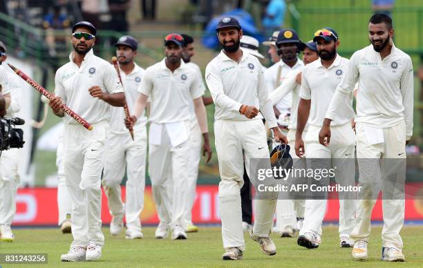 Indian cricketers celebrates after their victory in the third and final Test match between Sri Lanka and India at the Pallekele International Cricket...