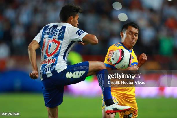 Jonathan Urretaviscaya of Pachuca struggles for the ball with Alberto Costa of Tigres during the 4th round match between Pachuca and Tigres UANL as...