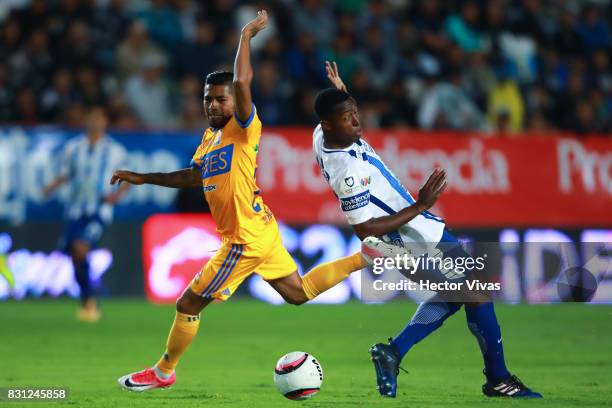 Oscar Murillo of Pachuca struggles for the ball with Javier Aquino of Tigres during the 4th round match between Pachuca and Tigres UANL as part of...
