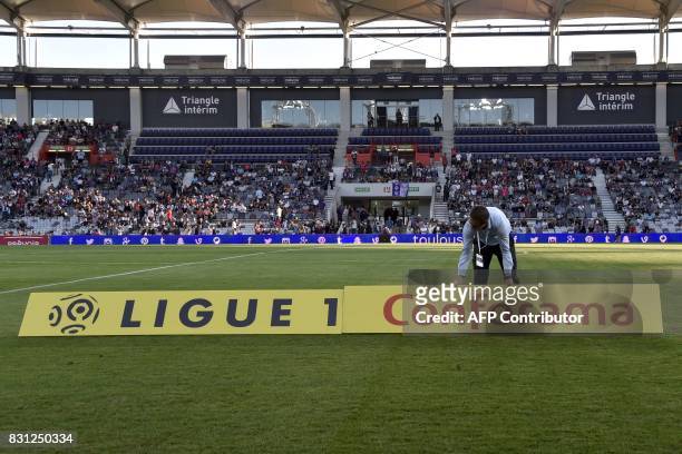 The new sponsor logo "Ligue 1 - Conforama" is installed prior to the French Ligue 1 football match between Toulouse and Montpellier at the Municipal...