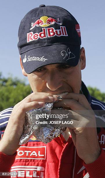 Spain's Daniel Sordo eats a sandwich in the technical area during the second stage of the 44 th Rally of Catalonia in El Molar near Tarragona on...