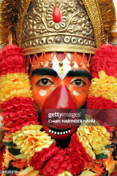 An Indian Hindu devotee, dressed as the monkey god Hanuman, participates in a religious procession to celebrate the festival of Dussehra at the...