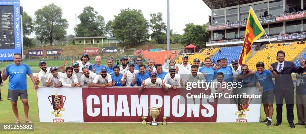 Indian cricketers pose for photographers after victory in the third day of the third and final Test match between Sri Lanka and India at the...