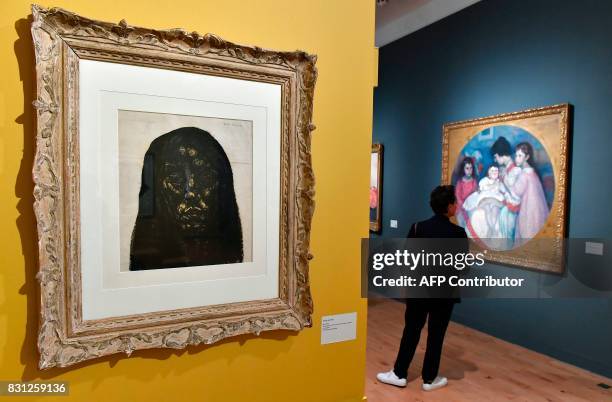 Visitor looks at a painting by French artist and painter Georges Dorignac during the exhibition "Georges Dorignac, le trait sculpte" at the Galerie...