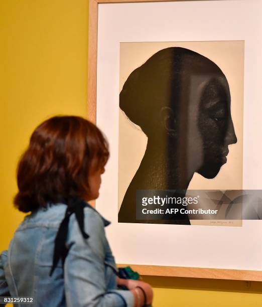 Visitor looks at the painting "Portrait de femme au chignon" , by French artist and painter Georges Dorignac during the exhibition "Georges Dorignac,...