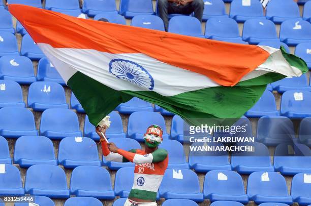 An Indian cricket fan celebrates after victory of the Indian team on the last day of the third and final Test match between Sri Lanka and India at...