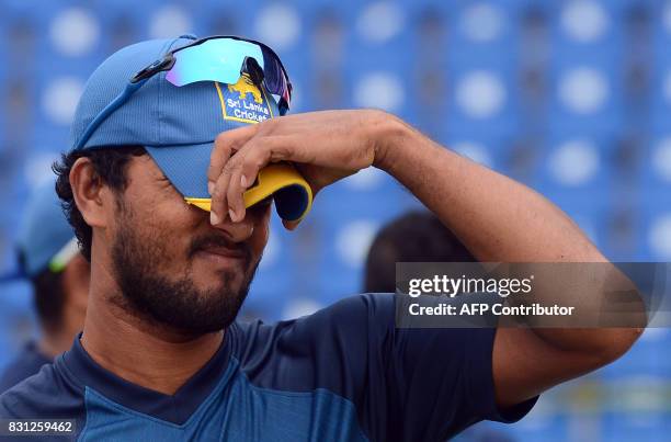 Sri Lankan cricket captain Dinesh Chandimal reacts after a presentation ceremony on the last day of the third and final Test match between Sri Lanka...