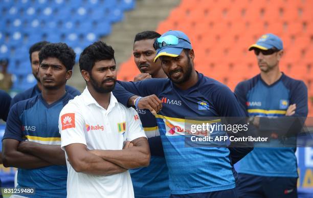 Sri Lankan cricketers react during the presentation ceremony after India's victory on the last day of the third and final Test match between Sri...