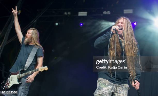 John Tardy and Trevor Peres of Obituary performing live on stage on day 3 at Bloodstock Festival at Catton Hall on August 13, 2017 in Burton Upon...