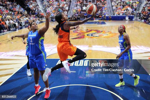 Courtney Williams of the Connecticut Sun drives to the basket past Courtney Paris of the Dallas Wings during the Connecticut Sun Vs Dallas Wings,...