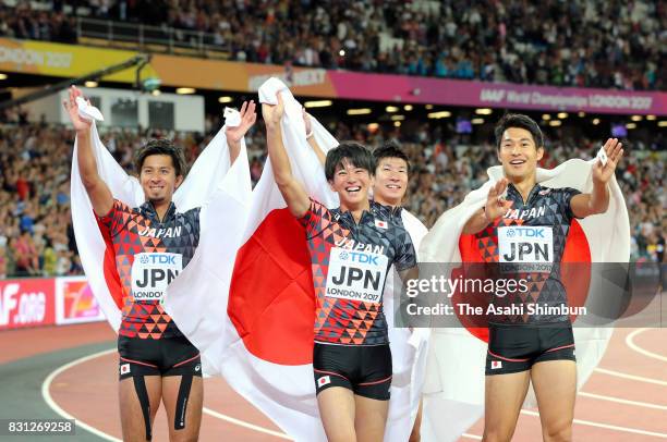 Shuhei Tada, Shota Iizuka, Yoshihide Kiryu and Kenji Fujimitsu of Japan celebrate winning bronze in the Men's 4x100 Relay final during day nine of...