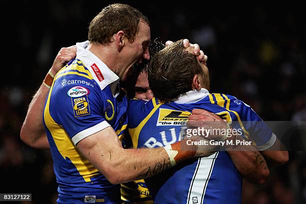 Leeds try scorer, Lee Smith is congratulated by teamates Scott Donald and Rob Burrow after scoring his team's opening try during the engage Super...