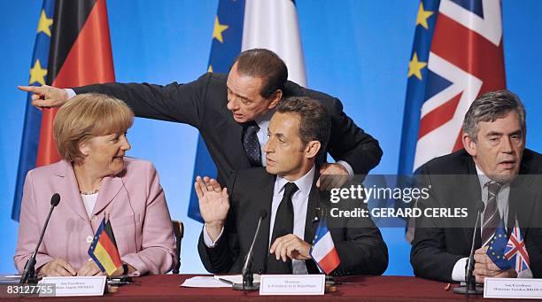 French President Nicolas Sarkozy , flanked by German chancellor Angela Merkel, Italian Prime Minister Silvio Berlusconi and British Prime Minister...