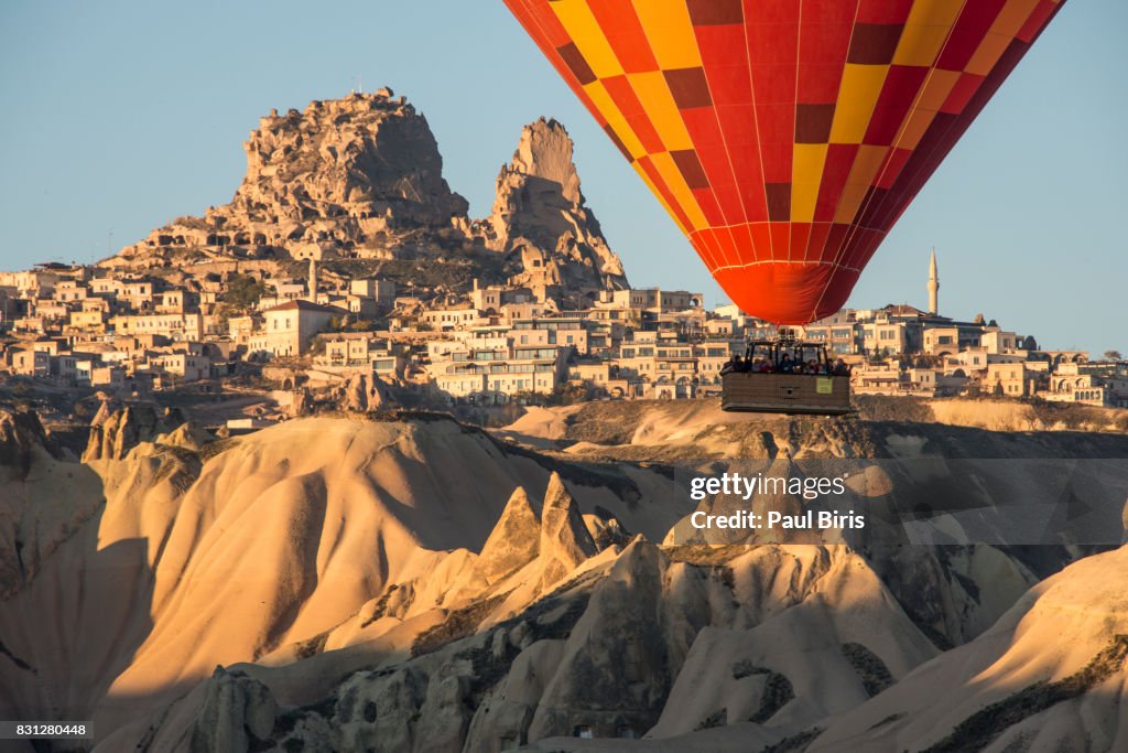 Turkey, Central Anatolia, Cappadocia, Hot air balloon flying over Uchisar Castle near Goreme