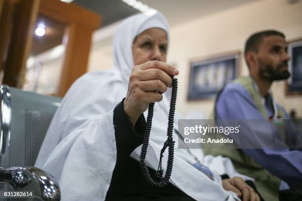 Prospective pilgrim woman prays as she waits to cross Rafah border crossing before moving forward to the Muslims' Holiest city of Mecca of Saudi...