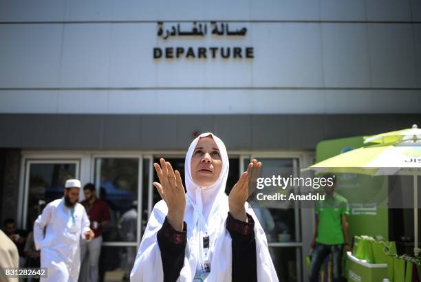 Prospective pilgrim woman prays as she waits to cross Rafah border crossing before moving forward to the Muslims' Holiest city of Mecca of Saudi...