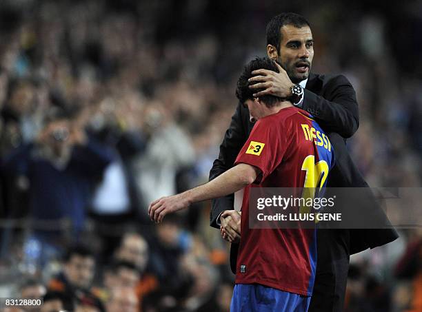 Barcelona's coach Pep Guardiola congratulates his Argentinian attacker Leo Messi after he is substituted during their Spanish League football match...