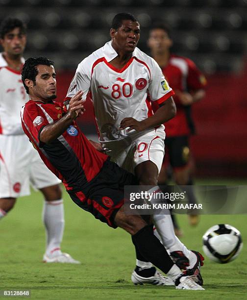 Al-Arabi's Brazilian forward Carlos Henrique Kim fights for the ball with Al-Rayyan's player Yunes Ali during their Qatar Stars League football match...