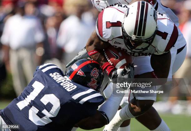 Jamarca Sanford of the Ole Miss Rebels tackles Captain Munnerlyn of the South Carolina Gamecocks during their game at Vaught-Hemingway Stadium on...
