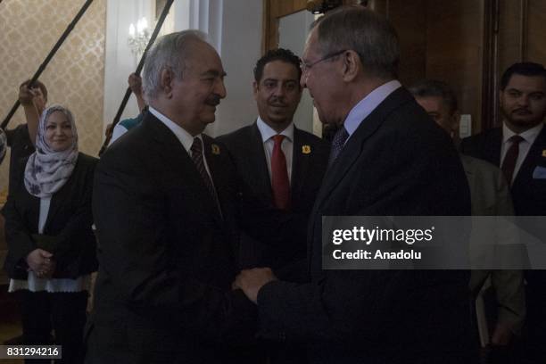 Russian Foreign Minister Sergei Lavrov and Libyan National Army Commander Khalifa Haftar shake hands before their meeting in Moscow, Russia on August...