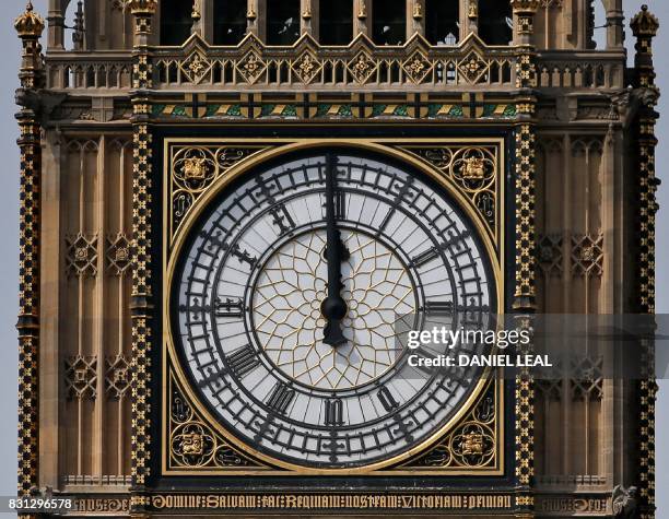 One of the four faces of the Great Clock of the Elizabeth Tower, commonly referred to as Big Ben, is pictured at the Houses of Parliament at midday...