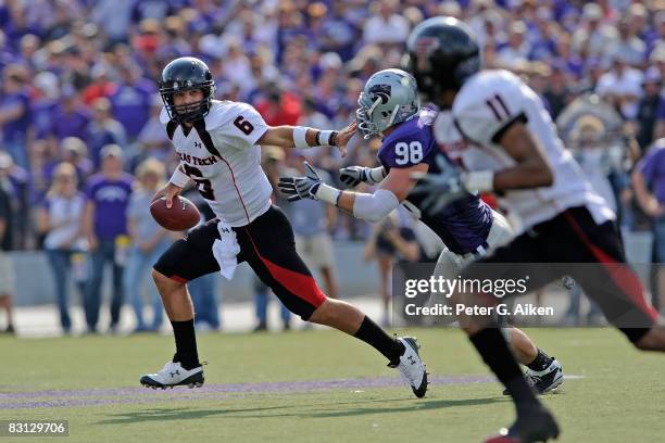 Quarterback Graham Harrell of the Texas Tech Red Raiders scrambles away from pressure from defensive end Ian Campbell of the Kansas State Wildcats in...