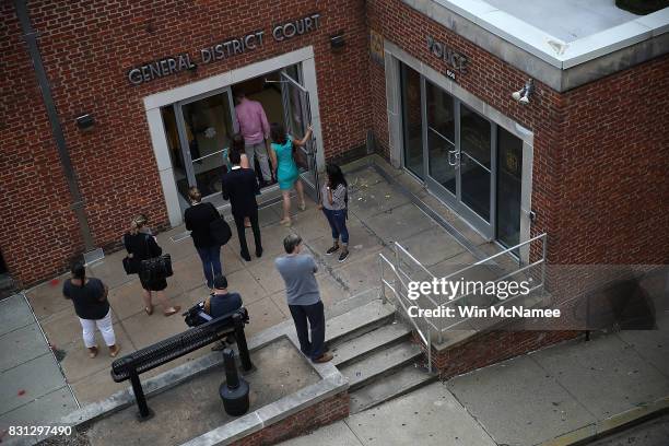 Reporters enter of the Charlottesville General District Court before a scheduled appearance via video link for James Alex Fields Jr. August 14, 2017...