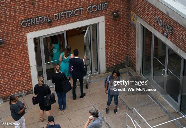 Reporters enter of the Charlottesville General District Court before a scheduled appearance via video link for James Alex Fields Jr. August 14, 2017...