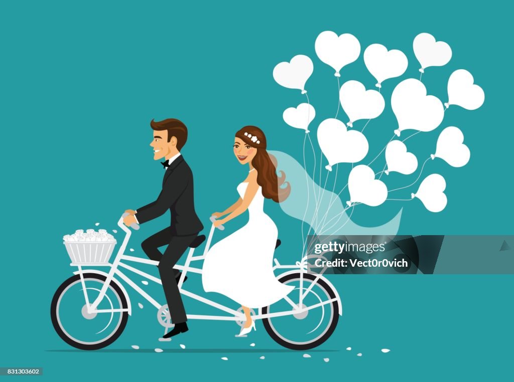 Just married couple bride and groom riding tandem bicycle