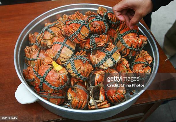 People enjoy steaned hairy crabs at a restaurant on October 4, 2008 in Suzhou of Jiangsu Province, China. Autumn is the best season for eating hairy...