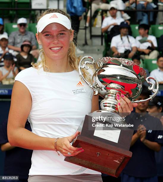 Caroline Wozniacki of Denmark poses with the trophy after the win over Kaia Kanepi of Estonia in the womens singles final on day seven of the AIG...