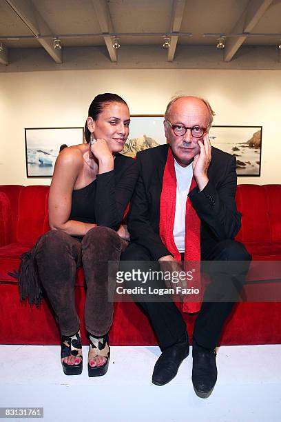 Fine art photographer Horst Wackerbarth poses with a fan at "The Red Couch", the inaugural exhibition of photographic artwork by Wackerbarth at...