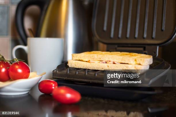 high angle view of ham and cheese toasted sandwich on breakfast - tosti stockfoto's en -beelden