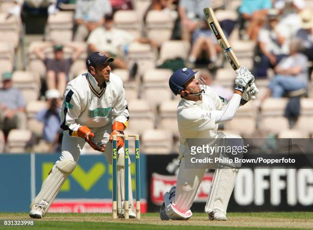 Michael Vaughan of Yorkshire hits a delivery from Hampshire's Shane Warne for a boundary during his innings of 72 runs watched by Hampshire...