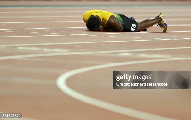 Usain Bolt of Jamaica falls to the track in the Men's 4x100 Relay final during day nine of the 16th IAAF World Athletics Championships London 2017 at...