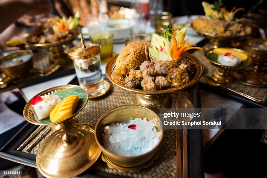 A set of Traditional Thai food Khao Chae on brass bowls and platters