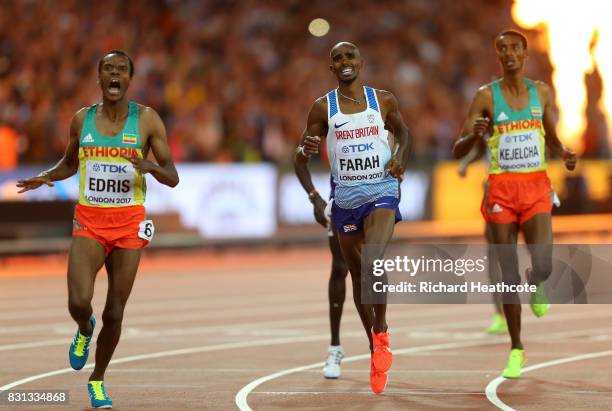 Muktar Edris of Ethiopia and Mohamed Farah of Great Britain reacts as they cross the finishline in the Men's 5000 Metres final during day nine of the...