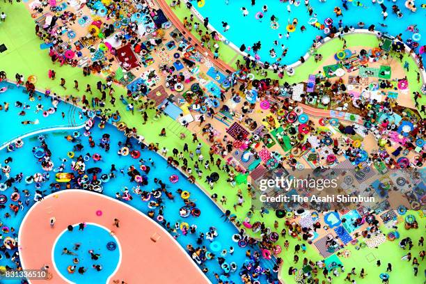 People enjoy at a pool at Hirakata Park amusement park on August 14, 2017 in Hirakata, Osaka, Japan. The temperature in Osaka exceeded 30 degrees...