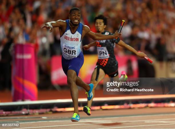 Nethaneel Mitchell-Blake of Great Britain crosses the finishline to win gold ahead of Kenji Fujimitsu of Japan, bronze, in the Men's 4x100 Relay...