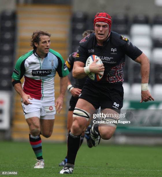 Alun Wyn Jones of the Ospreys charges upfield to set up the first try during the EDF Energy Cup match between Ospreys and Harlequins at the Liberty...