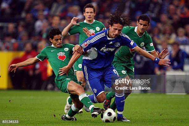 Kevin Kuranyi of Schalke is challenged by Josue , Sascha Riether and Ricardo Costa of Wolfsburg during the Bundesliga match between FC Schalke 04 and...