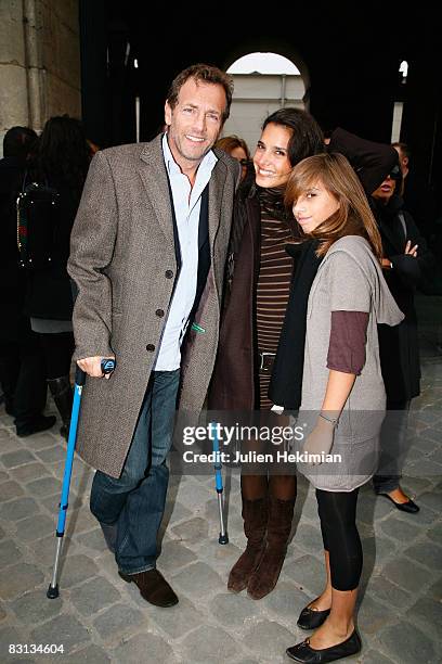 Stephane Freiss his wife Ursula and their daughter Camille leave the Louis Vuitton fashion show during Paris Fashion Week Spring/Summer '09 on...