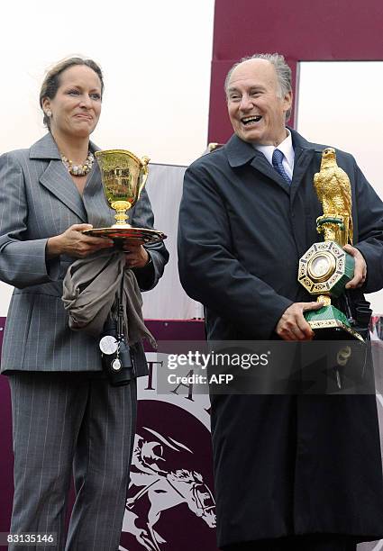 Zarkava's owner-breeder Karim The Aga Khan and daughter Princess Zahra poses with trophies after three-year-old filly ridden by Belgian jockey...
