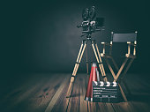 Video, movie, cinema concept. Retro camera, clapperboard and director chair. 3d