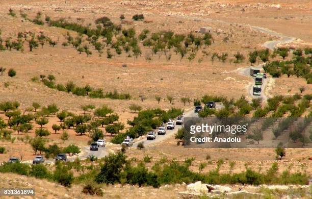Syrian refugees and members of Ahrar al-Sham connected with Free Syrian Army are seen on the way back their home country with buses and vehicles...