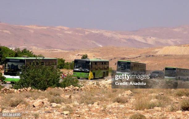 Syrian refugees and members of Ahrar al-Sham connected with Free Syrian Army are seen on the way back their home country with buses and vehicles...